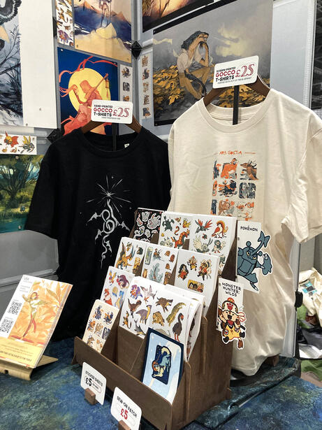 Part of my convention table set-up featuring stickers and T-shirts.